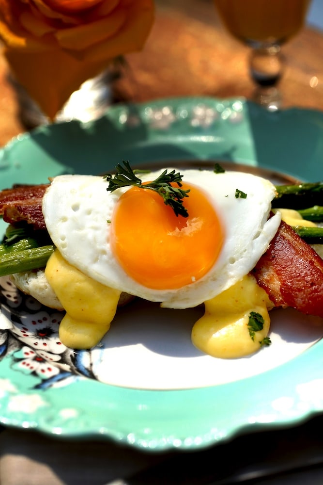 Southern-style eggs benedict over biscuits, asparagus and hollandaise sauce