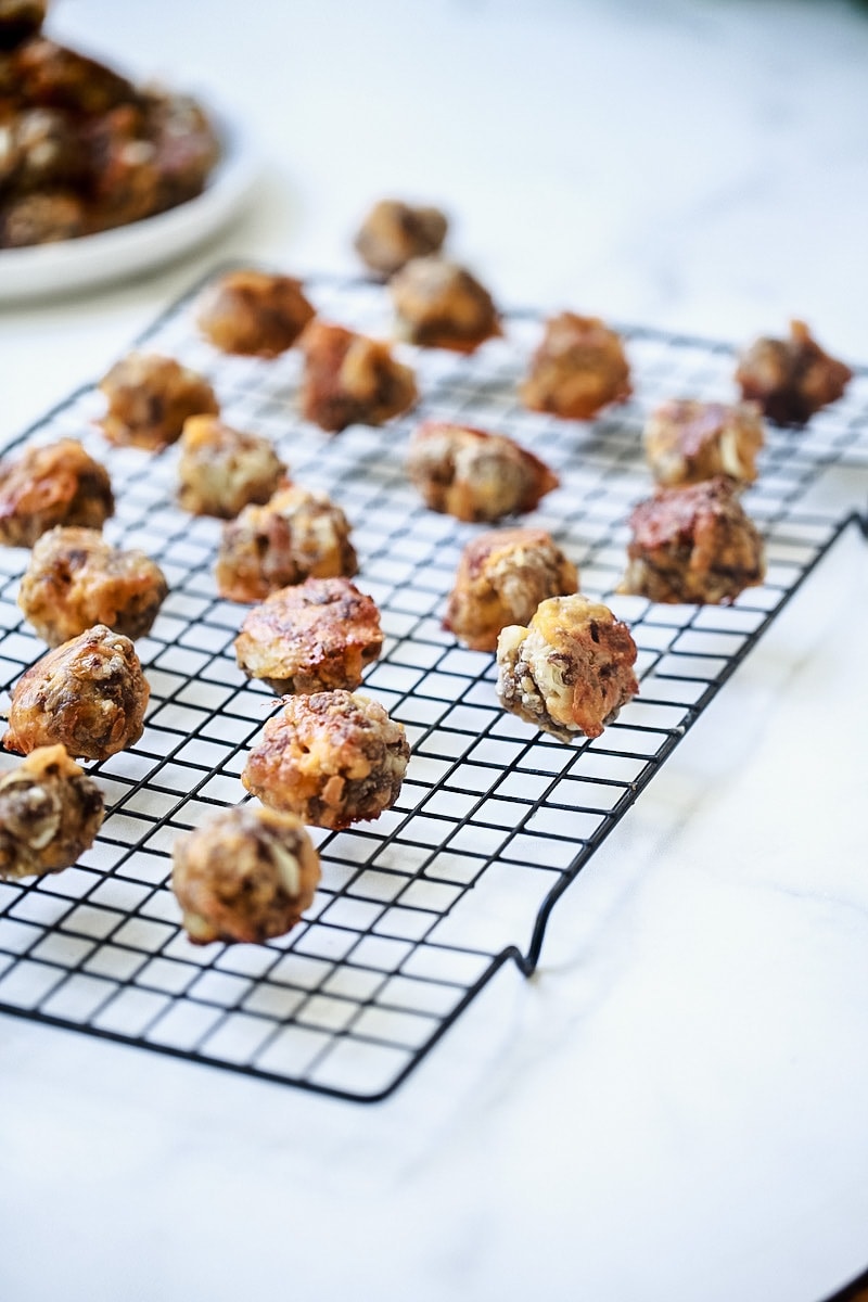 Sausage Balls with Cheese on Cooling Rack on White Marble