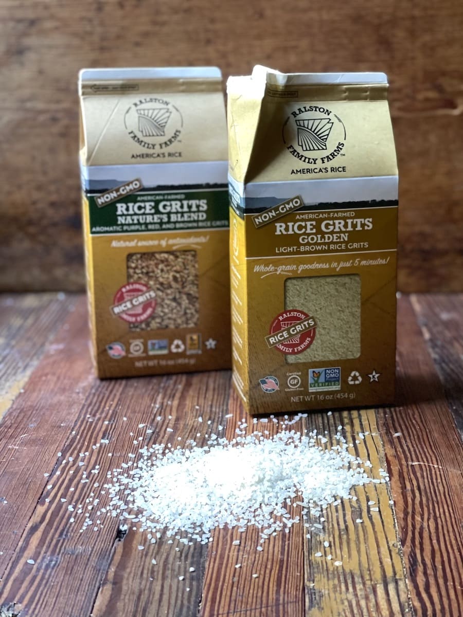 Ralston Rice Grits two packages on a wooden surface with the grits on the board