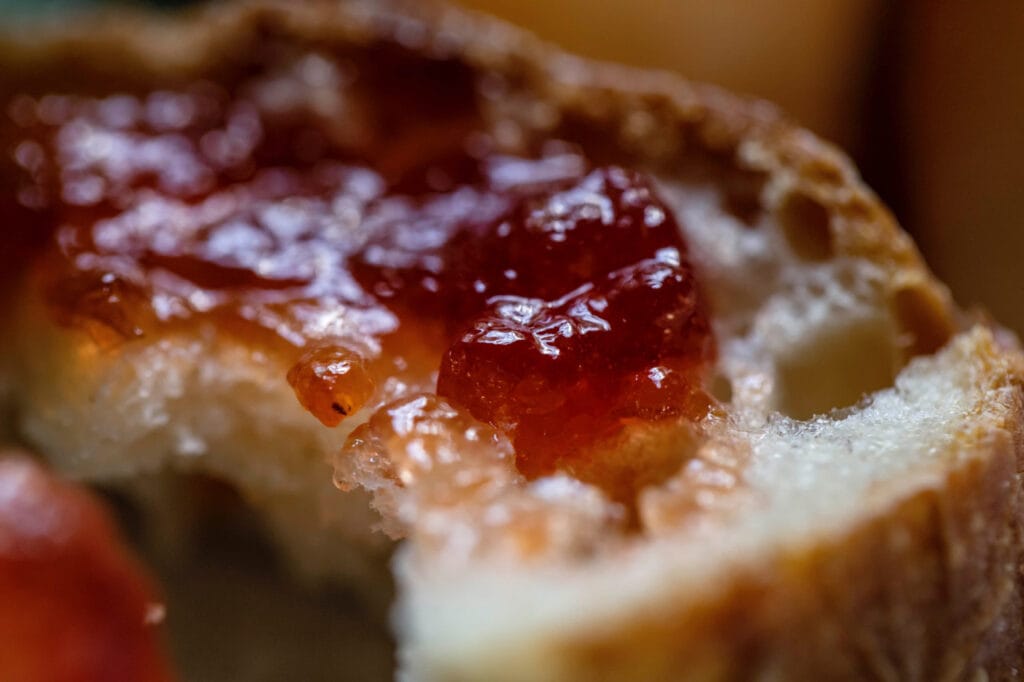 closeup of bread slice spread with strawberry jam from recipe